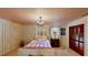 Charming bedroom features a striped wall and chandelier lighting at 625 Woodlawn Cemetery Rd, Gotha, FL 34734