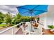 Spacious deck featuring outdoor seating, a large umbrella and wooded view perfect for entertaining and relaxation at 625 Woodlawn Cemetery Rd, Gotha, FL 34734