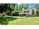 Expansive property with lush lawn, mature trees, and a charming home featuring a large deck at 625 Woodlawn Cemetery Rd, Gotha, FL 34734
