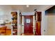 Elegant foyer with a wooden front door, hardwood floors, and decorative shelving, leading to a modern kitchen at 625 Woodlawn Cemetery Rd, Gotha, FL 34734