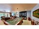 Large game room with a billiards table and adjacent living room at 625 Woodlawn Cemetery Rd, Gotha, FL 34734
