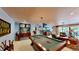 Entertain in this stylish game room with a pool table, spiral staircase and views to the outdoor patio at 625 Woodlawn Cemetery Rd, Gotha, FL 34734