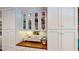 Custom kitchen cabinets provide ample storage space to the butlers pantry area, with glass front cabinets at 625 Woodlawn Cemetery Rd, Gotha, FL 34734