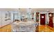 Bright kitchen features a large marble island with seating and custom white cabinetry at 625 Woodlawn Cemetery Rd, Gotha, FL 34734