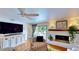 Cozy living room features a fireplace, ceiling fan, and sliding glass door to the patio at 625 Woodlawn Cemetery Rd, Gotha, FL 34734