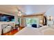 Bright main bedroom with french doors leading to deck with outdoor views at 625 Woodlawn Cemetery Rd, Gotha, FL 34734