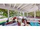 Sunroom with white coffered ceiling, comfortable seating, and views of the landscaped yard at 625 Woodlawn Cemetery Rd, Gotha, FL 34734