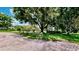 Expansive yard with mature trees and split rail fence, offering ample space and privacy at 625 Woodlawn Cemetery Rd, Gotha, FL 34734
