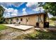 Backyard patio with outdoor seating, surrounded by lush greenery, perfect for relaxation at 6310 Lake Underhill Rd, Orlando, FL 32807