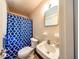 Bathroom featuring a decorative shower curtain, toilet, and sink at 6310 Lake Underhill Rd, Orlando, FL 32807
