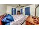 Bedroom featuring blue accents, natural light, a ceiling fan and wood furnishings at 6310 Lake Underhill Rd, Orlando, FL 32807