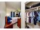 Bedroom with closet featuring clothes, bags, and organizers, with wood furnishings at 6310 Lake Underhill Rd, Orlando, FL 32807