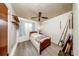 Bedroom featuring wood floors, a fan, window, and fishing rods at 6310 Lake Underhill Rd, Orlando, FL 32807