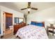 Bedroom with double bed, wooden dresser, and bathroom access at 6310 Lake Underhill Rd, Orlando, FL 32807