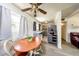 Bright dining area featuring a wooden table, ceiling fan, and easy access to the kitchen at 6310 Lake Underhill Rd, Orlando, FL 32807