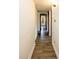 Hallway with wood floor and cabinets for storage at 6310 Lake Underhill Rd, Orlando, FL 32807