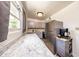 Well-lit kitchen with marble counters, grey cabinetry, and stainless steel appliances at 6310 Lake Underhill Rd, Orlando, FL 32807