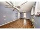 Bright living room with wood floors, ceiling fans, and a window offering natural light at 6310 Lake Underhill Rd, Orlando, FL 32807