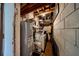 Basement utility room featuring a water heater, washer, and exposed ductwork at 6310 Lake Underhill Rd, Orlando, FL 32807
