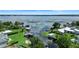 Beautiful aerial view of waterfront homes with boat docks and lush landscaping on a sunny day at 65 Oakdale St, Windermere, FL 34786