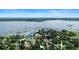 Breathtaking aerial showcasing waterfront houses surrounded by mature trees and a serene lake at 65 Oakdale St, Windermere, FL 34786