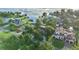 Gorgeous aerial view features lakeside homes with boat docks and lush landscaping, under a clear sky at 65 Oakdale St, Windermere, FL 34786