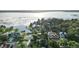 Aerial view of a residential area with waterfront properties, lush greenery, and scenic lake views at 65 Oakdale St, Windermere, FL 34786