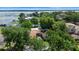 Aerial view features stunning waterfront homes surrounded by lush trees and a beautiful lake at 65 Oakdale St, Windermere, FL 34786