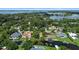 Panoramic aerial view of homes on a lake, featuring landscaped yards and tranquil scenery at 65 Oakdale St, Windermere, FL 34786