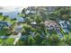 Aerial view shows waterfront homes nestled among mature trees, offering stunning views and a serene setting at 65 Oakdale St, Windermere, FL 34786