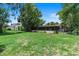 Expansive green backyard with a screened-in porch and mature trees, perfect for outdoor relaxation at 65 Oakdale St, Windermere, FL 34786