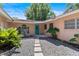 Charming home with well-maintained landscaping, a bright blue door, and stone walkway at 65 Oakdale St, Windermere, FL 34786