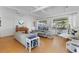 Bright living room with vaulted ceilings, modern furniture, and natural light from large windows at 65 Oakdale St, Windermere, FL 34786