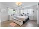 Bright primary bedroom featuring light-colored walls, neutral furniture, and natural light at 65 Oakdale St, Windermere, FL 34786
