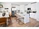 Stylish kitchen with white cabinets, stainless steel appliances, a kitchen island, and modern stools at 651 Pennywort St, Lake Alfred, FL 33850