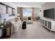 Spacious, well-lit living room featuring a modern TV, comfortable seating and stylish decor at 651 Pennywort St, Lake Alfred, FL 33850