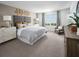 Serene bedroom featuring soft colors, a large window, comfortable furnishings, and stylish decor at 651 Pennywort St, Lake Alfred, FL 33850