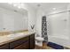 Full bathroom with vanity, sink, mirror, and a shower/tub combination with patterned curtain at 827 Grandin St, Davenport, FL 33837