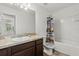 Full bathroom with vanity, sink, mirror, and a shower/tub combination with patterned curtain at 827 Grandin St, Davenport, FL 33837