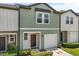 Inviting two-story townhome with a one-car garage and charming, well-maintained landscaping at 827 Grandin St, Davenport, FL 33837