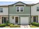 Inviting two-story townhome with a one-car garage and charming, well-maintained landscaping at 827 Grandin St, Davenport, FL 33837
