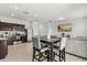 Open-concept living and dining area featuring stainless steel appliances and modern finishes at 827 Grandin St, Davenport, FL 33837