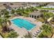 Aerial view of a sparkling community pool surrounded by lush landscaping and lounging areas at 827 Grandin St, Davenport, FL 33837