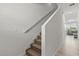 Bright staircase with carpeted steps and white railing leading to the upper level of the home at 827 Grandin St, Davenport, FL 33837