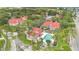 An aerial view showcases the community with a swimming pool, lush greenery, and red-tiled roofs at 900 Northern Dancer Way # 204, Casselberry, FL 32707