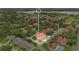 An aerial view shows the home with a red roof surrounded by lush greenery at 900 Northern Dancer Way # 204, Casselberry, FL 32707