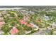 An aerial shot capturing a residential area with vibrant red-tiled roofs, lush greenery, and roadways at 900 Northern Dancer Way # 204, Casselberry, FL 32707