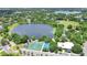 Aerial view of community park featuring a lake, tennis courts, recreation fields, and scenic green spaces at 900 Northern Dancer Way # 204, Casselberry, FL 32707