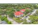 Aerial view of the community with lush trees, grey condos with red roofs and a well-manicured lawn at 900 Northern Dancer Way # 204, Casselberry, FL 32707