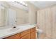Full bathroom with a sink vanity with wood finish, white toilet and shower with curtain at 900 Northern Dancer Way # 204, Casselberry, FL 32707